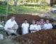 The missionaries stand in the cistern they dug for the local parish.