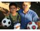 Two young boys make friends over the universal language of soccer.