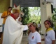 During the commissioning Mass, Bishop Pedro Pablo Elizondo lays hands on a young missionary's head.