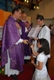 Newly consecrated member Joana Ferraz receives a Bible from Fr Aromir. The acolyte is her Legionary brother.