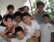 Missionaries and local kids give the thumbs up and "V" for victory sign.