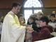 Fr Richard Sutter, LC, chaplain at Christian Brothers School in City Park, distributes Communion to students.