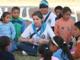 A Woodlands Academy alumni leads the Rosary for some children.
