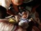 An injured child receives medical treatment after the Haiti earthquake in Port-au-Prince on January 13, 2010. Photograph by Eduardo Munoz, Reuters.