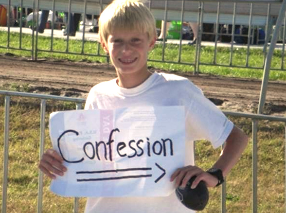An ECYD boy promotes the sacrament of Confession.