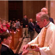 Father Anthony Bannon distributing Communion.