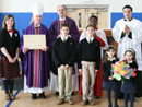 Bishop Malooly recieves gifts from Woodmont students. Father Steven Reilly, L.C. and Brother Ugo Piasentin, L.C. help to present the gift.