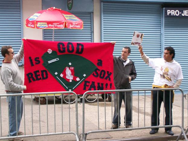 Diehard Red Sox fans bring their banner to the gates of Yankee Stadium.